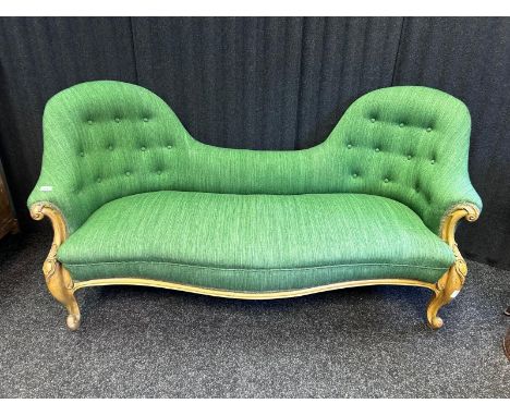Victorian walnut sofa, the double spoon back above a hair filled seat, the whole covered in a green buttoned upholstery, rais