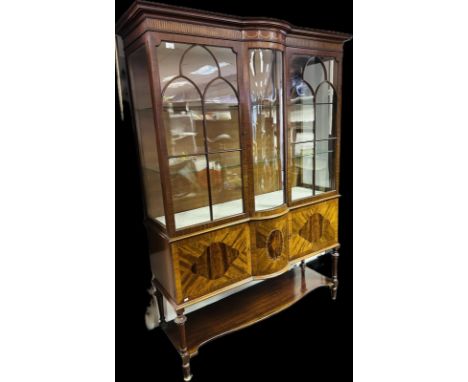 Edwardian mahogany inlaid cabinet, the moulded cornice above an inlaid frieze and glazed astragal doors opening to shelved in
