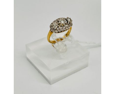 18ct yellow gold ladies ring, three centre larger diamonds surrounding by small diamonds comes with original box marked Macka