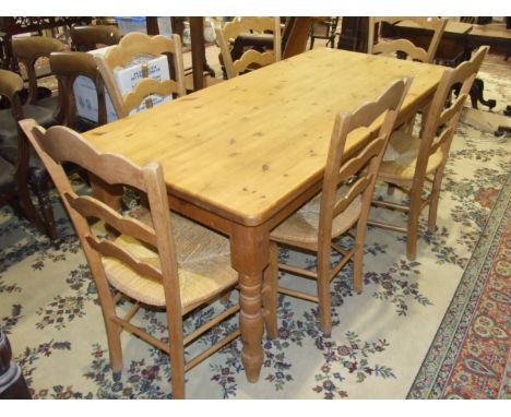 A modern pine rectangular kitchen table on turned legs, 181 x 85cm, together with a set of six pine rush seated ladder-back c