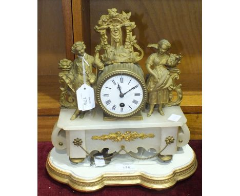 A gilt metal and alabaster mantel clock with French drum movement, pendulum and key, 31cm high and a wooden plinth.