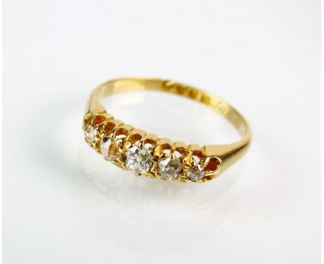 An 18ct gold five stone graduated diamond ring, the old cut diamonds claw set to yellow gold shank, engraved 'Jan 15 09', rin