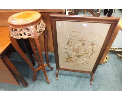 A Chinese hardwood jardiniere stand on slender cabriole legs and a tapestry work fire screen detailed with an exotic bird in 