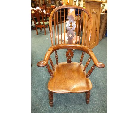 A 19th century elm and yew wood Windsor chair with pierced vase and stick back raised on ring turned tapering legs