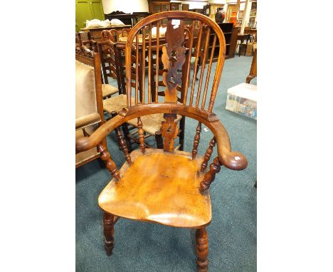 A 19th century elm and yew wood armchair with pierced vase splat and stick back on ring turned legs