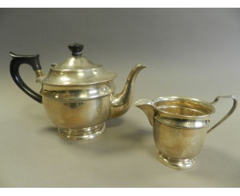 A silver teapot and cream jug, hallmarked Sheffield by Emile Vimer