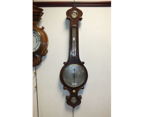 A 19th century rosewood framed onion topped wheel barometer with silvered dial and thermometer and level marked J Bainton, 95