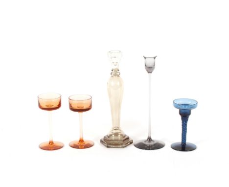 A pair of Wedgwood amber tinted glass candle holders; a blue glass example; a Wedgwood lead crystal candlestick; and another 