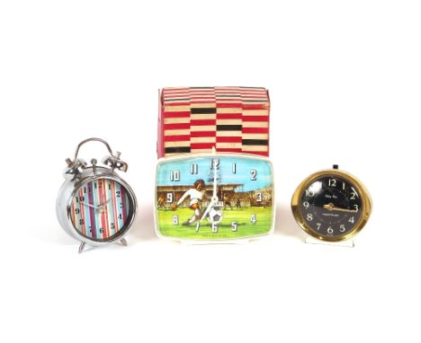 A Smiths 30 hour alarm clock, with football decoration, in original box; a Westclox Baby Ben alarm clock; and another