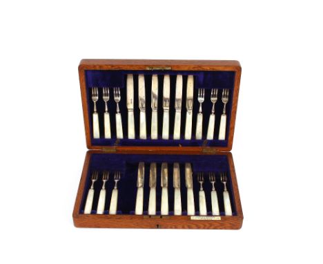 A cased set of 12 silver and mother of pearl handled fruit forks; together with 11 matching knives, in fitted light oak case 