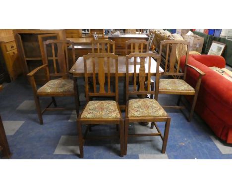 An Oak Drawer Leaf Dining Table and Six Tapestry Upholstered Chairs 