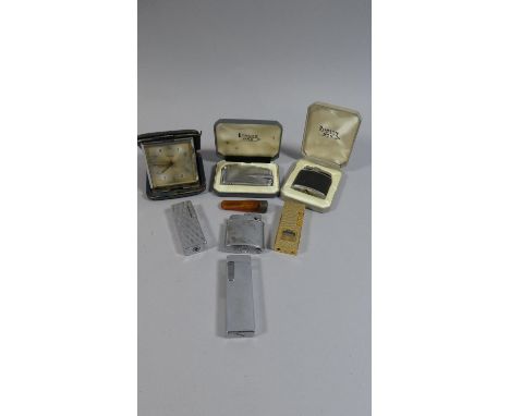 A Tin of Curios to Include Six Lighters, Amber Cheroot Holder and an Alarm Clock etc 
