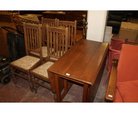 AN OAK DROP LEAF TABLE AND FOUR CHAIRS