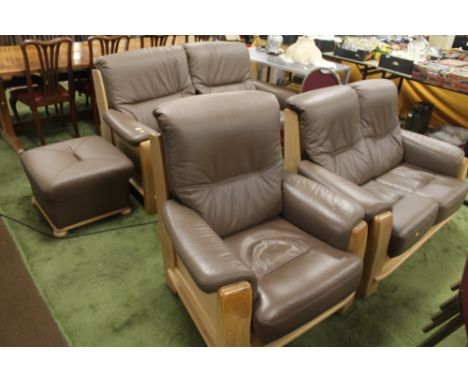 A MODERN LEATHER AND WOOD THREE PIECE SUITE TOGETHER WITH A MATCHING POUFFE 