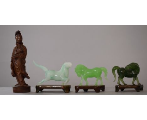 Three Oriental Jade Effect Glass Studies of Horses on Wooden Stands Together with a Carved Figure of Guanyin, 17.5cms High 