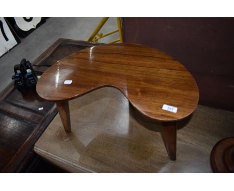 A vintage occasional table having kidney shaped top and triple splay legs