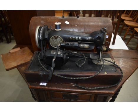 A vintage singer sewing machine (electric) in oak case , wiring removed for safety