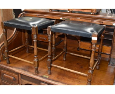 Two vintage oak framed and leather footstools