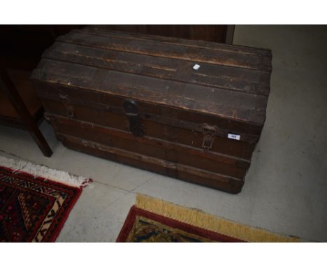 A vintage dome top travel trunk