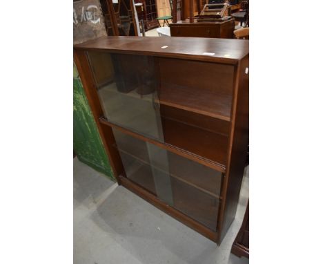 A vintage sapele bookcase having glass sliding doors, width approx. 91cm