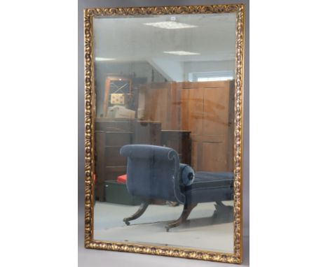 A large gilt frame rectangular wall mirror with a raised geometric border, &amp; inset with a bevelled plate, 193.75cm x 132c