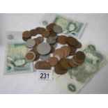 A mixed lot of old coins and three £1 notes.