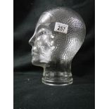 A glass male head.