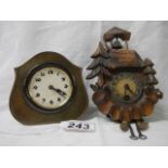 Two miniature mantel clocks.