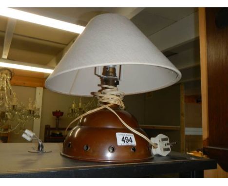 An old copper washing diolly made in to a table lamp. 