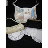 A shoulder bag and two evening bags.