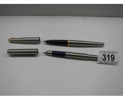 Two Parker fountain pens.