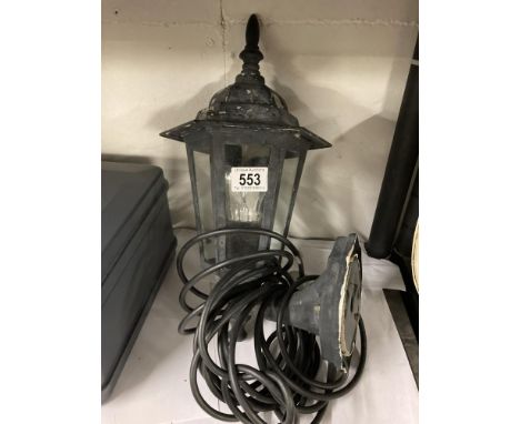 A carriage lantern style wall lamp with cable and plug 