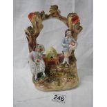 A rare 19th century Staffordshire flat back figure featuring a beehive.