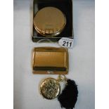 An Estee Lauder compact, a Stratton compact and a Melissa compact.