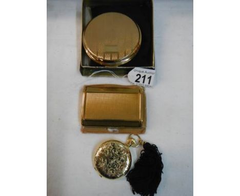 An Estee Lauder compact, a Stratton compact and a Melissa compact. 