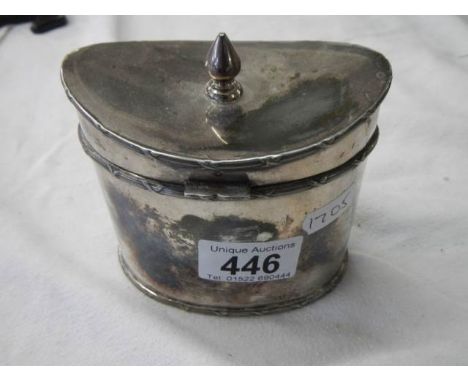 A silver plate tea caddy in the shape of a Victorian hat box. 