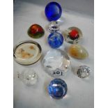 Eleven assorted glass paperweights.