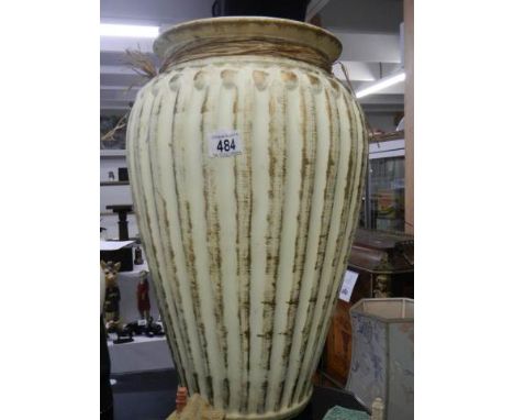 A tall ceramic vase. 