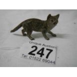 A small painted bronze cat.