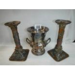 A pair of early 20th century plated candlesticks and a twin handled urn.
