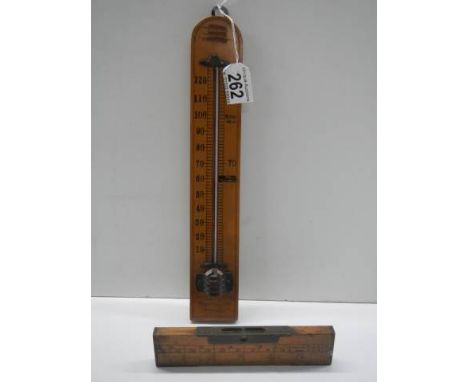 A vintage thermometer and spirit level. 