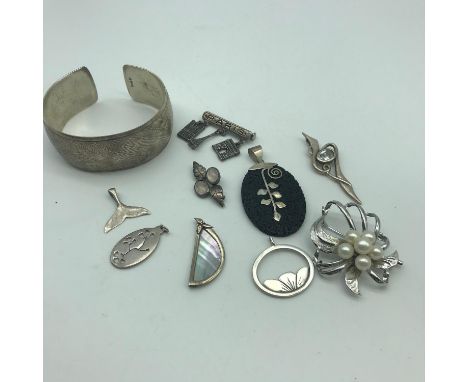 A Lot of silver jewellery which includes 800 grade bangle, Silver &amp; pearl brooch, Silver leaf and moon stone brooch &amp;