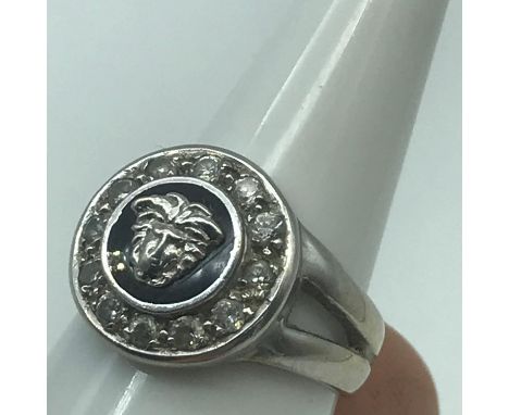 A 9ct white gold Altinbas ring designed in a Versace style. Showing Medusa like head surround by a black backing and surround