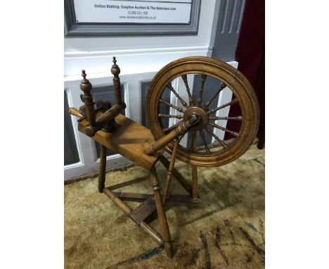 A Victorian spinning wheel. In a working condition. One strap needs replaced to hold bobbin in place. 