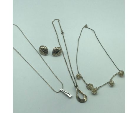 A Lot of three silver 925 necklaces with silver pendants. One pendant has a single diamond. Together with a pair of sterling 