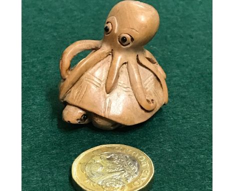 Japanese hand carved netsuke of a Octopus on top of a turtle. Signed by the artist. 3.4cm in height 
