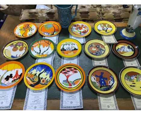 A Collection of 14 Wedgwood The Bizarre living landscape plates by Clarice Cliff. Together with a wade squirrel jug. 