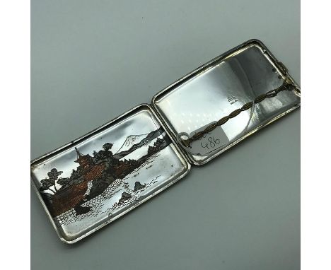 A Sterling silver Chinese pagoda scene cigarette case. Measures 8x12x1cm 