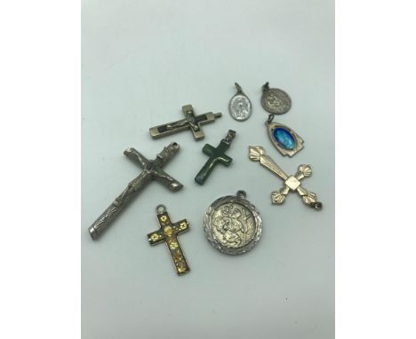 A Lot of 9 Religious pendants which includes 925 Sterling silver and green agate cross pendant 