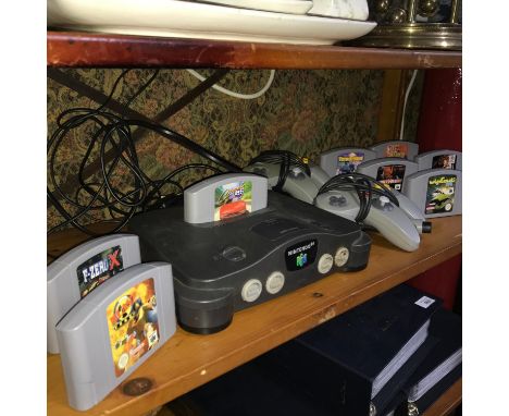 A Vintage Nintendo 64 console with two controllers and 9 games which includes Duke Nukem, Hardcore ECW Revolution, Wipe-out 6